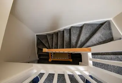 a staircase in a house with black and white stairs at Luxury 5BDR with City Access, Free Parking and Wi-Fi in Ince-in-Makerfield
