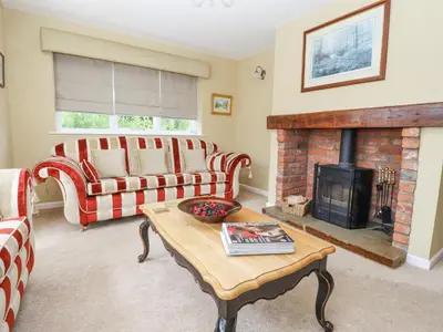 a living room with a couch and a fireplace at The Old Coach House in Preston