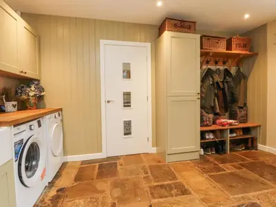 a laundry room with a washer and dryer at The Old Coach House in Preston