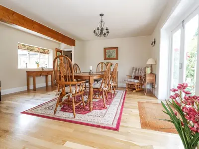 a dining room with a table and chairs at The Old Coach House in Preston