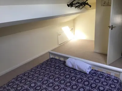 a bedroom with a bed with a pillow on it at Bridge Villas in Garstang