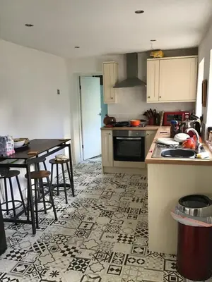 a kitchen with a counter and a table with chairs at Bridge Villas in Garstang