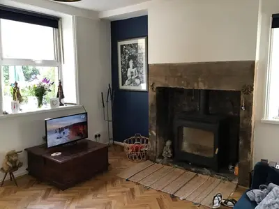 a living room with a fireplace and a tv at Bridge Villas in Garstang