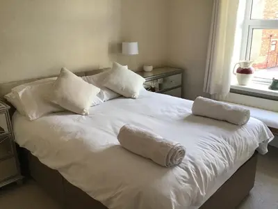 a large white bed with two pillows and a window at Bridge Villas in Garstang
