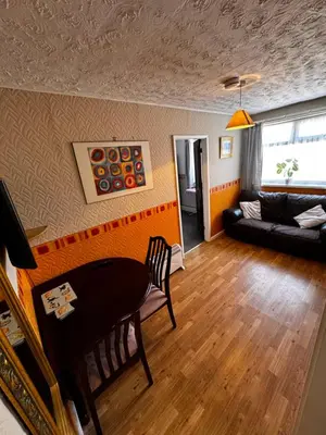 a living room with a table and a couch at Beachside Bliss In Blackpool 1 Bed Apartment in Blackpool
