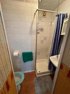 a bathroom with a shower and a toilet and a sink at Beachside Bliss In Blackpool 1 Bed Apartment in Blackpool