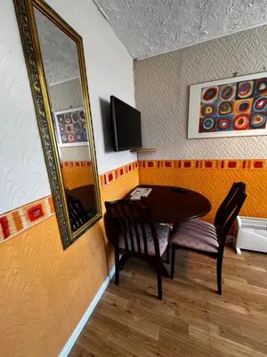 a dining room with a table and a mirror at Beachside Bliss In Blackpool 1 Bed Apartment in Blackpool