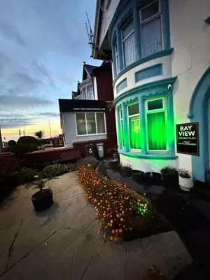 a house with green lights on the side of it at Beachside Bliss In Blackpool 1 Bed Apartment in Blackpool
