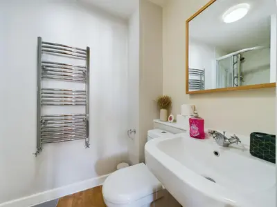 a bathroom with a sink and a toilet and a mirror at Group-Friendly City-Centre Flat Wifi, sleeps 4 in Liverpool