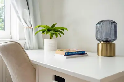 a desk with a plant and a lamp and books at Modern London stay near Nothing Hill in Hoghton