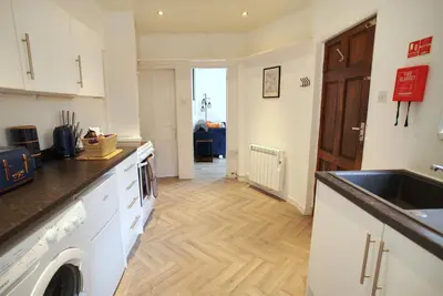 a kitchen with a sink and a counter top at Signature Coastal Suites - Two Chic & Stylish Apartments by Parydise Properties in Morecambe