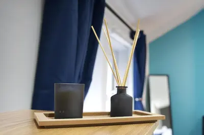a table with two vases and a glass on it at Signature Coastal Suites - Two Chic & Stylish Apartments by Parydise Properties in Morecambe