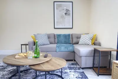 a living room with a couch and a table at Signature Coastal Suites - Two Chic & Stylish Apartments by Parydise Properties in Morecambe