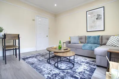 a living room with a couch and a table at Signature Coastal Suites - Two Chic & Stylish Apartments by Parydise Properties in Morecambe