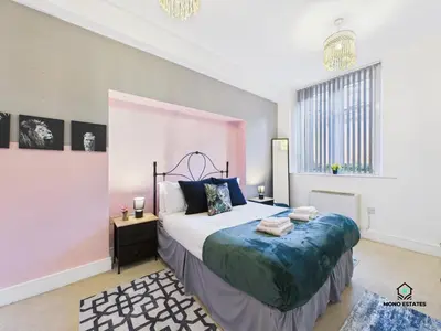 a bedroom with a bed and a large window at Knowledge Quarter - Near Uni and Lime St - 2 En Suite, 1 WC in Liverpool