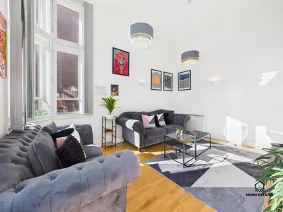a living room with two couches and a table at Knowledge Quarter - Near Uni and Lime St - 2 En Suite, 1 WC in Liverpool
