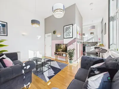 a living room with couches and a fireplace at Knowledge Quarter - Near Uni and Lime St - 2 En Suite, 1 WC in Liverpool