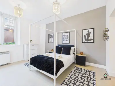a white bedroom with a canopy bed in it at Knowledge Quarter - Near Uni and Lime St - 2 En Suite, 1 WC in Liverpool