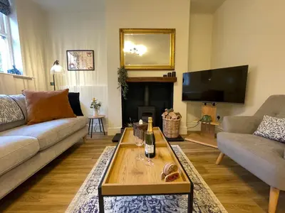 a living room with a couch and a tv at 3 Chapel Square in Lancaster