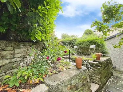 a garden with flowers and a stone wall at 3 Chapel Square in Lancaster
