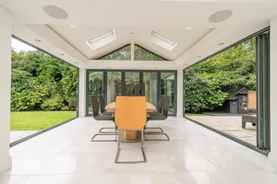 an extension to a house with a conservatory with a table and chairs at The Luxury Country Home in Aughton
