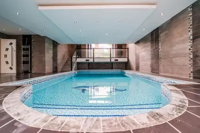 a large swimming pool in a large room at The Luxury Country Home in Aughton