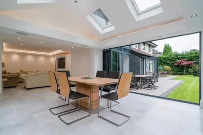 a living room with a wooden table and chairs at The Luxury Country Home in Aughton