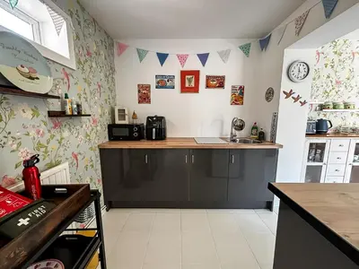 a kitchen with a counter and a sink in a room at Yellow House Cottage in Southport