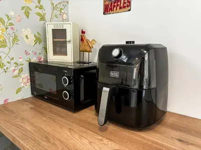 a coffee maker and a microwave on a table at Yellow House Cottage in Southport