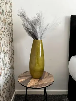 a green vase sitting on top of a table at Yellow House Cottage in Southport