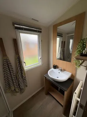 a bathroom with a sink and a mirror at Lush Lake View in Millom