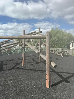 a wooden fence in a playground at Lush Lake View in Millom
