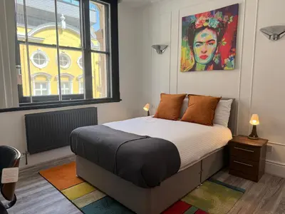 a bedroom with a bed and a large window at Trendy Penthouse, Liverpool City Centre in Liverpool