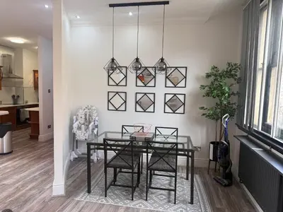 a dining room with a glass table and chairs at Trendy Penthouse, Liverpool City Centre in Liverpool