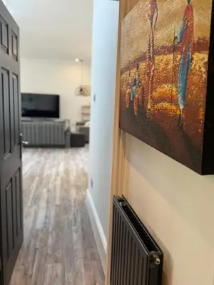 a hallway with a painting hanging on a wall at Trendy Penthouse, Liverpool City Centre in Liverpool