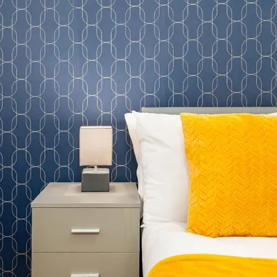 a bedroom with a bed and a blue wall at Beautiful 3BR Flat near LFC Stadium - Sleeps 8 in Liverpool