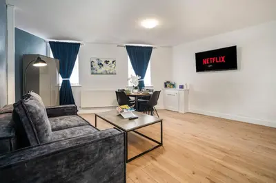 a living room with a couch and a table at Beautiful 3BR Flat near LFC Stadium - Sleeps 8 in Liverpool