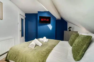 a bedroom with a bed with towels on it at Beautiful 3BR Flat near LFC Stadium - Sleeps 8 in Liverpool