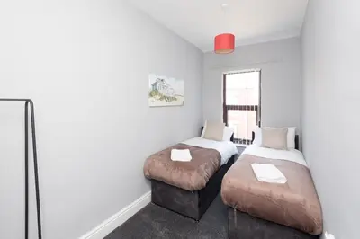 a bedroom with two beds and a window at 3-Bed Coastal Retreat in Waterloo