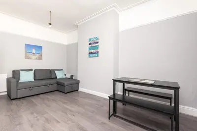 a living room with a couch and a table at 3-Bed Coastal Retreat in Waterloo