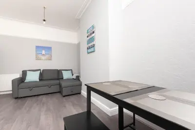 a living room with a couch and a table at 3-Bed Coastal Retreat in Waterloo