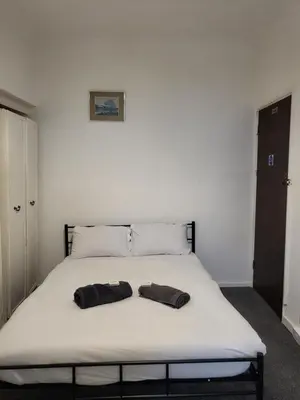 a bed with two black glasses on top of it at Tulip Hotel Blackpool in Blackpool