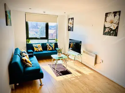 a living room with a couch and a table at Claire Stay Apartment in Liverpool