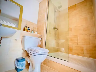 a bathroom with a toilet and a glass shower at Claire Stay Apartment in Liverpool