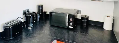 a room with a microwave and other appliances at Claire Stay Apartment in Liverpool