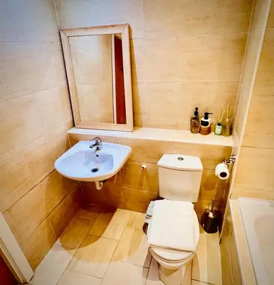 a bathroom with a toilet and a sink at Claire Stay Apartment in Liverpool