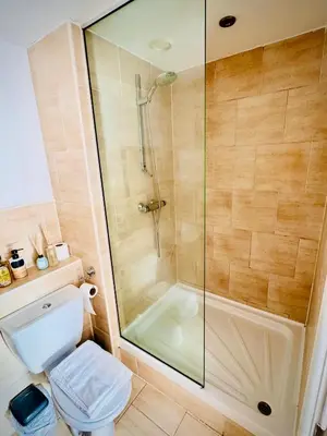 a bathroom with a shower and a toilet at Claire Stay Apartment in Liverpool
