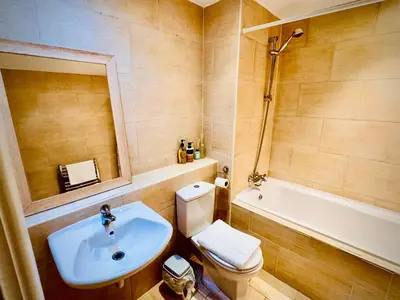 a bathroom with a sink and a toilet and a tub at Claire Stay Apartment in Liverpool