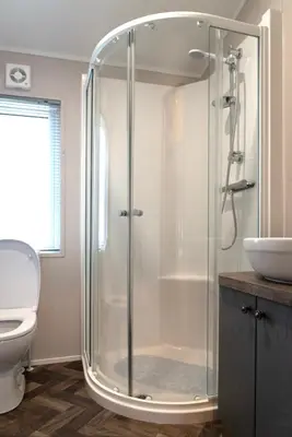 a shower with a glass door in a bathroom at Bittern Lodge: 3BD Retreat in South Lakeland Park in Borwick