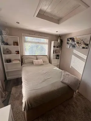 a bedroom with a large bed and a window at Birkdale Golf Open Holiday Home in Southport